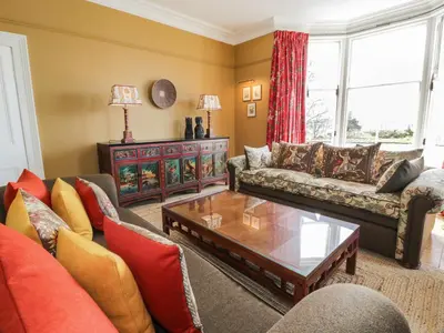 a living room with a couch and a coffee table at Auchenvhin - Rockcliffe in Dalbeattie