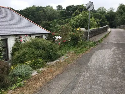 a road next to a house with flowers and a street light at The Haven B&B in Castle Douglas