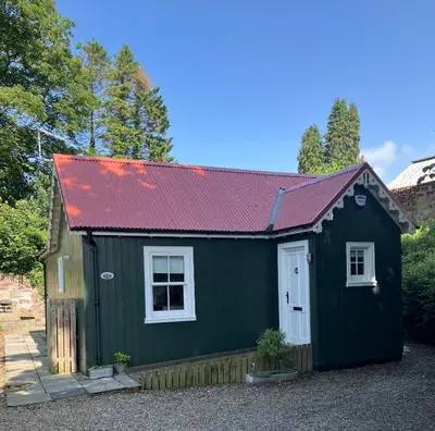 a green tiny house with a red roof at Wee Dipper Cottage Maybole in Maybole