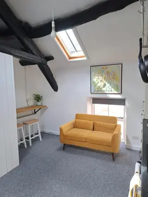 a living room with a couch and a table at The Snug in Cockermouth