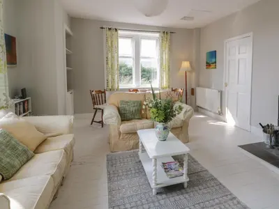 a living room with a couch and a table at West Lodge in Dumfries