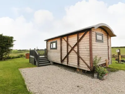 a tiny house on a trailer in a yard at Greenacres Carriage in Maybole