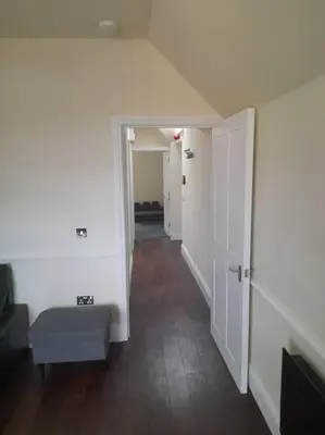 a hallway with an open door to a room at Kirkcudbright Holiday Apartments - Apartment F in Kirkcudbright