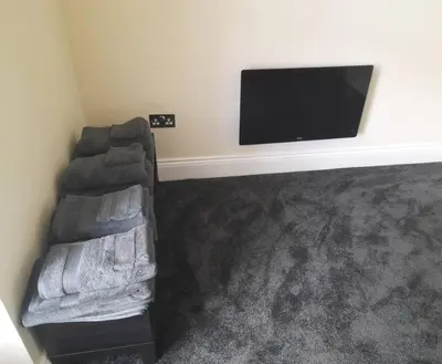 a living room with a couch and a flat screen tv at Kirkcudbright Holiday Apartments - Apartment F in Kirkcudbright