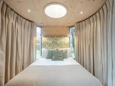 a bed in a room with a window at The Treehouse Caerlaverock - Uk45028 in Carsethorn