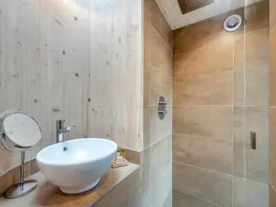 a bathroom with a white sink and a shower at The Treehouse Caerlaverock - Uk45028 in Carsethorn
