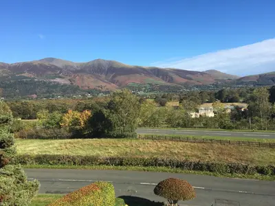 a view of a road with mountains in the background at Maple Bank Country Guest House in Keswick