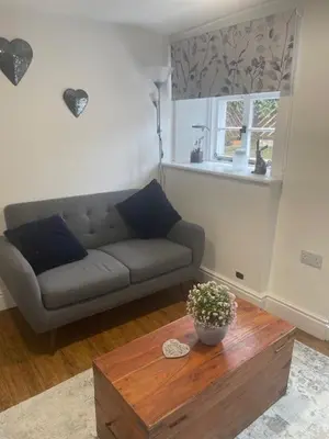 a living room with a couch and a coffee table at White House in Carlisle
