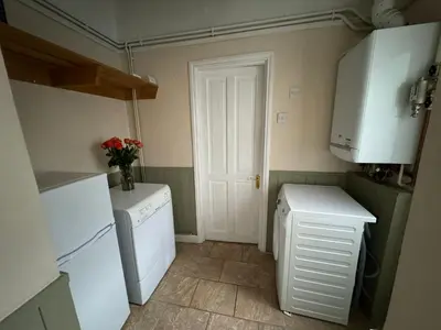 a kitchen with a refrigerator and a washer and dryer at Ennerdale Edge - 4 Bedrooms - Sleeps 8 in Cleator Moor