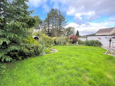 a yard with green grass and a tree at Traditional Scottish Cottage in Beautiful Location - Pass the Keys in Rockcliffe