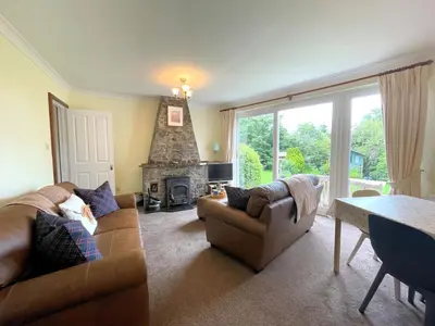 a living room with a couch and a fireplace at Traditional Scottish Cottage in Beautiful Location - Pass the Keys in Rockcliffe