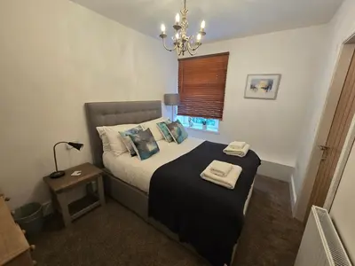 a bedroom with a bed with two towels on it at The Plough Inn in Carlisle
