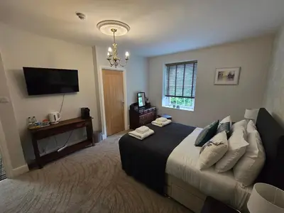 a bedroom with a bed and a flat screen tv at The Plough Inn in Carlisle