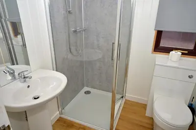 a bathroom with a shower and a sink at Lagavulin 3 in Portpatrick