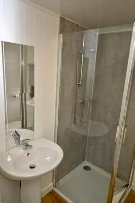 a bathroom with a sink and a shower at Lagavulin 3 in Portpatrick