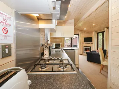 a kitchen with a stove top in a tiny house at Canadian Cabin 37 in Keswick