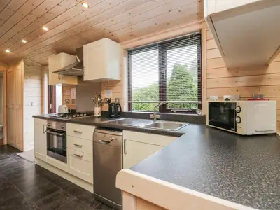 a kitchen with a sink and a counter top at Canadian Cabin No 38 in Keswick