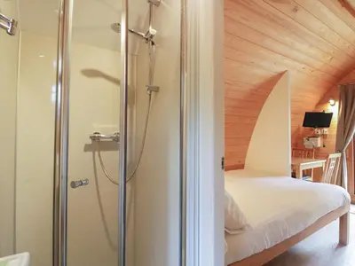 a bathroom with a shower and a bed in a room at Pod No 6 in Keswick