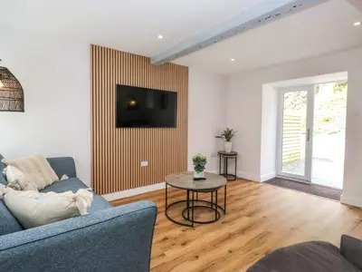 a living room with a couch and a table at Riverside Cottage No 4 in Keswick