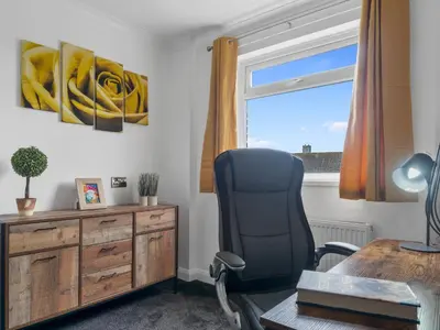 an office with a desk and a chair and a window at Mountain View Beautiful Large House By Cockermouth in Cockermouth