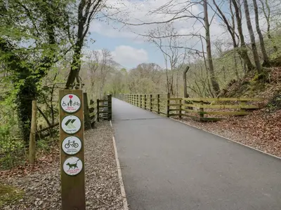 a path in the woods with signs on it at Pod No 28 in Keswick