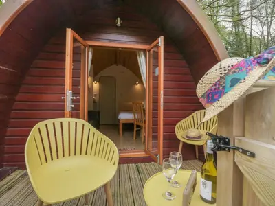 a small cabin with two chairs and a table at Pod No 28 in Keswick