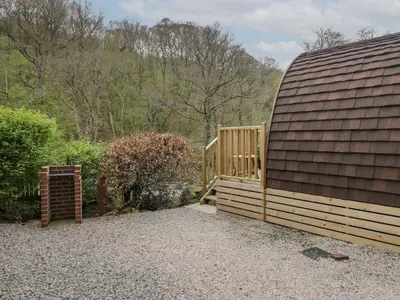 a small building with a wooden ramp next to it at Pod No 5 in Keswick