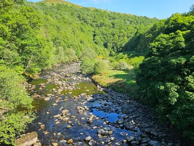 an aerial view of a river with rocks and trees at Beech Timber Lodge in Keswick