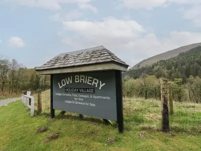 a sign for a low battery battery village on the side of a road at Canadian Cabin No 39 in Keswick