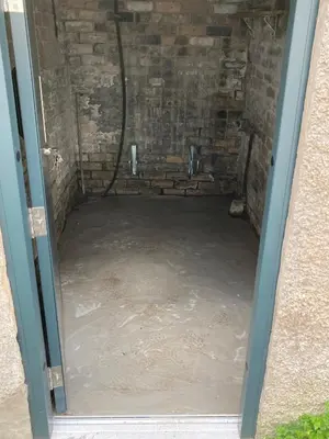 a door to a basement with a concrete floor at 25 Church Street in Keswick