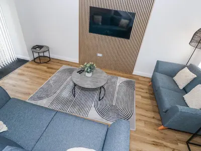 a living room with a couch and a table at Riverside Cottage No 3 in Keswick