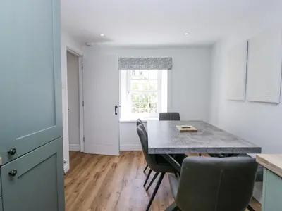 a kitchen with a table and chairs and a window at Riverside Cottage No 3 in Keswick