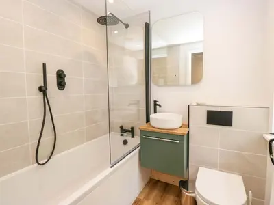a bathroom with a shower and a toilet at Riverside Cottage No 5 in Keswick