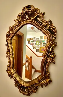an ornate mirror on a wall in a room at Elm Tree Lodge in Keswick