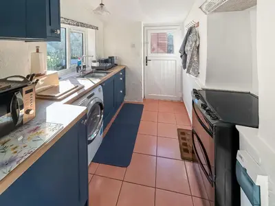 a kitchen with a washer and dryer in it at Swinside Cottage in Ennerdale Bridge