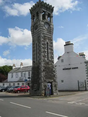 a clock tower on the side of a street at Laghead Cottage in Gatehouse of Fleet