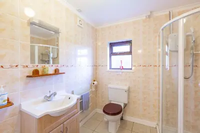 a bathroom with a toilet and a sink and a shower at Laghead Cottage in Gatehouse of Fleet