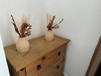 two vases sitting on top of a wooden dresser at Scotch Terrace - 3 Bedrooms - Sleeps 6 in Whitehaven
