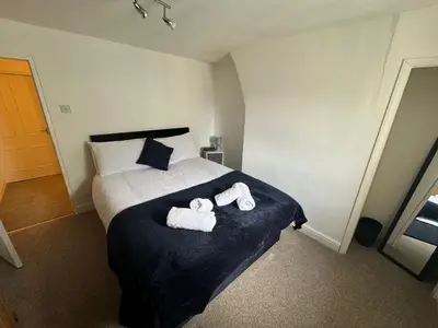 a bedroom with a bed with two towels on it at Scotch Terrace - 3 Bedrooms - Sleeps 6 in Whitehaven