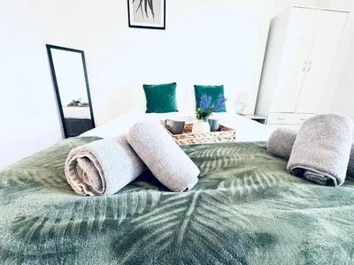 a bedroom with a bed with towels on it at The Georgian Townhouse - 4 Bedrooms - Sleeps 9 in Whitehaven
