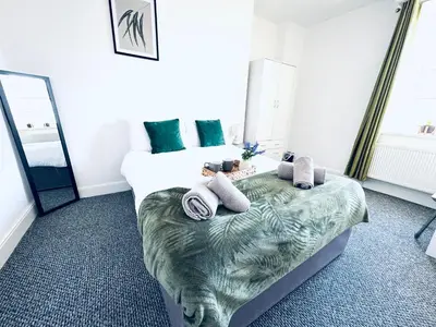 a bedroom with a large bed with towels on it at The Georgian Townhouse - 4 Bedrooms - Sleeps 9 in Whitehaven