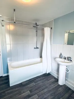 a bathroom with a bath tub and a sink at The Georgian Townhouse - 4 Bedrooms - Sleeps 9 in Whitehaven