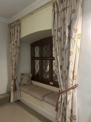 a window seat in a room with curtains at Moresby Hall Country House Hotel in Whitehaven