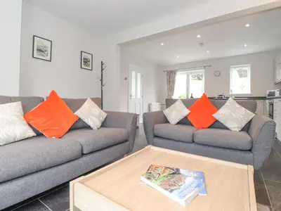 a living room with two couches and a coffee table at 1 Millbank in Keswick