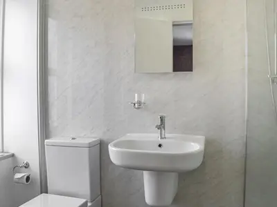 a white bathroom with a sink and a toilet at Montys in Castle Douglas