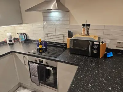 a kitchen with a counter top with a microwave at Carlisle City Centre The Wash House in Carlisle