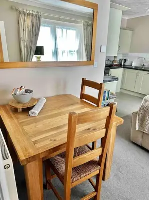 a wooden table in a kitchen with a bowl on it at A charming luxury apartment! in Portinscale