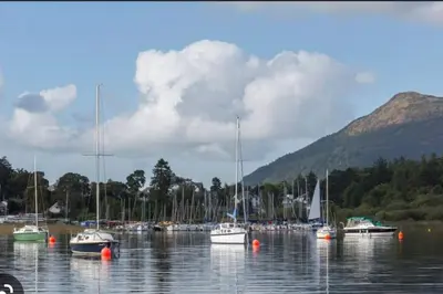 a bunch of boats in a body of water at A charming luxury apartment! in Portinscale