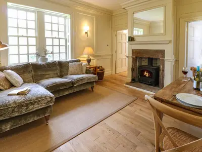 a living room with a couch and a fireplace at The Pavillion in Carlisle