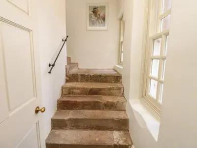 a staircase in a house with a window at The Pavillion in Carlisle